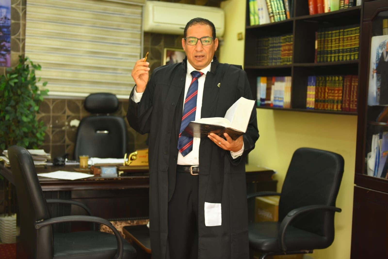 Mohamed Reda wearing court attire with a legal reference